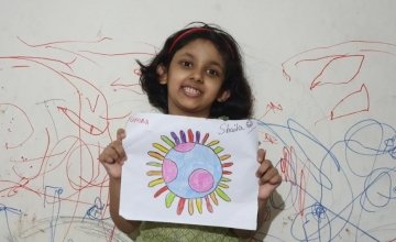 7-year-old Shalia with her artwork, Bangladesh.