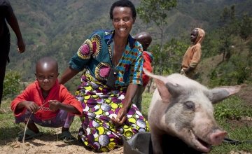 Violette and her son Lievain with the pig she has bought from the profits of her business at her home in Cibitoke, Burundi. She was a participant of Concern's livelihoods programme and her business has gone from strength to strength.