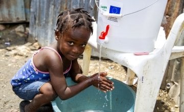 Cherica (2) washes her hands in front of her grandmother's home in Cite Soleil, a district of Port-au-Prince, Haiti. Photo: Dieu Nalio Chery/ Concern Worldwide