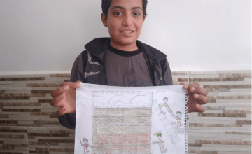 12-year-old Abdallah from Syria pictured here with his drawing of what he wants to be when he grows up: an architect. 