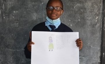 Ann from Kenya, pictured here with her drawing of what she wants to be when she grows up.