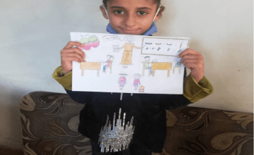10-year-old Fatima from Syria pictured with her drawing of what she wants to be when she grows up.