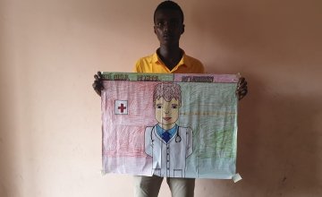 Mubarak pictured with his drawing of what he wants to be when he grows up, Somalia.