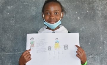 Purity from Kenya pictured here with her drawing of what she wants to be when she grows up.