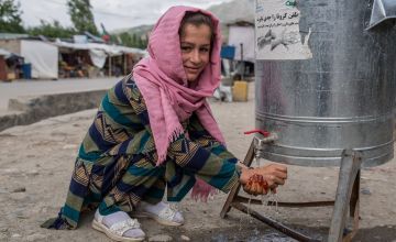 Kobra* washes their hands at the newly installed hand-washing station, Afghanistan. Photo: Stefanie Glinski