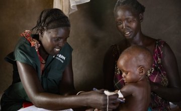 Concern Health Worker Rebekah visits Nyariemi and her eight-month-old son, Parnath, who is being treated for Severe Acute Malnutrition in their home in the Pugnido refugee camp, Ethiopia. Photo: Kieran McConville