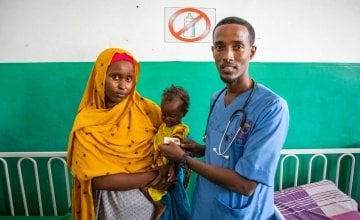 Mother Munira (28) with her 18 month old daughter Malika being seen by a Banadir Hospital Doctor. Malika became malnourished from acute diarrhoea.  Photo: Gavin Douglas/Concern Worldwide