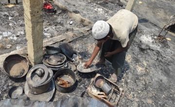 A Rohingya refugee searching through household materials from his home after the fire. Photo: Concern Wordwide.
