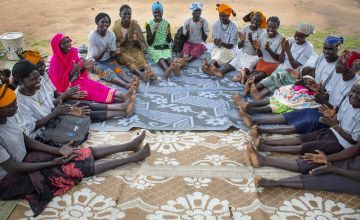 Women in a Mother's Group in South Sudan sit around in a circle