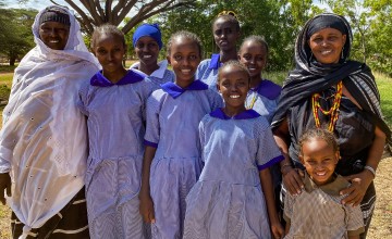 Women from the Chalbi Salt Self-Help Group with girls they have supported to stay in school