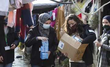 Team members of Concern distribute soap at an informal tented settlement in north Lebanon. Photo: Dalia Khamissy