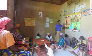 A community health worker teaches a Care Group about health, nutrition and good hygiene