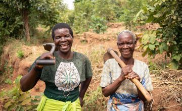 Mary Mandala and Eneles Mpela maintain the watershed in Phalombe, Malawi. Here they're cleaning the swale, which diverts water runoff down to the ground water supply instead of flooding the farms below. Photo: Chris Gagnon