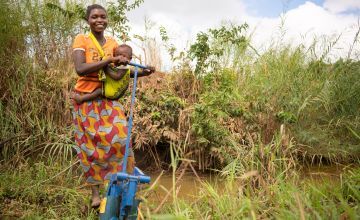 Eliza Phuziwa pictured with a water pump. Photo: Chris Gagnon/Concern Worldwide