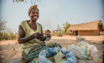 Ernestine, mother and grandmother of a large family, sells sugar and flour on the roadside, an income-generating activity she began with the help of Concern’s Graduation Project in Manono, Tanganyika. Photo: Pamela Tulizo/ Panos Pictures