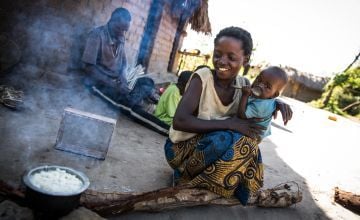 29-year-old Mado prepares breakfast to share with her husband and their two children, in the village of Pension, Manono Territory in DRC. Photo: Hugh Kinsella Cunningham