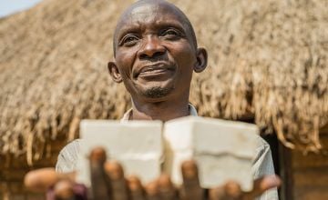 Mususa has been blind since he was forty and is the head of his household. Mususa runs his businesses with the help of his son, Joseph, selling homemade soap, cassava and palm oil, which he