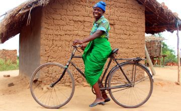 Jennifer Maganizo’s bike is a life-saver. Not only does she use it to transport her vegetables to market, but it cuts the journey time to the nearest hospital by seven hours. Photo: Jason Kennedy