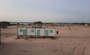 A health clinic made from shipping containers being constructed in a remote area of western Chad next to a settlement for people fleeing