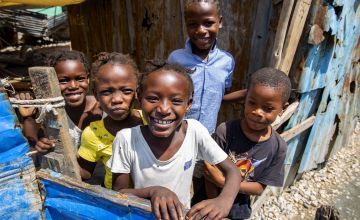 Children smile to camera in Cite Soleil slum, Haiti.