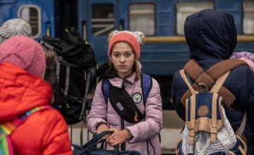 Yana* (11), is standing on the platform at Lviv train station, waiting to board a train to the Polish border. Photo: Stefanie Glinski/Concern Worldwide