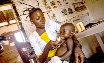 Annie feeds her 10-month-old baby, Mamadon, a sachet of therapeutic food to help him recover from malnutrition at Kiambi health centre, Manono Territory. Photo: Hugh Kinsella Cunningham/Concern Worldwide