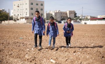 Three of Rima's children walking to school.