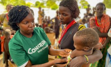 Concern staff checks the health of Nyanga (2.5 years old) at a health clinic in Marsabit, Kenya. Photo: Jennifer Nolan / Concern Worldwide 
