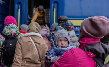 Daria* 2 years old, with her mother, boarding a train having fled their home. Photo: Stefanie Glinski/Concern Worldwide