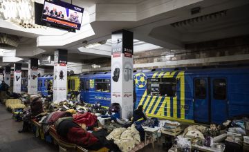 People lie on the floor in metro station, Ukraine, sheltering from ongoing fighting.