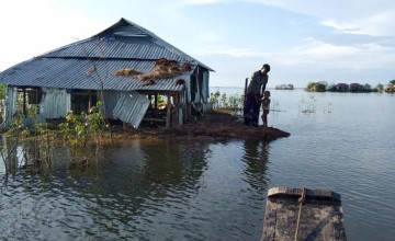 People in flood affected areas still surrounded by water. They are checking their houses to see whether they can return. These people need cash support for shelter repair. Photo: Rubel Talukder/Concern Worldwide