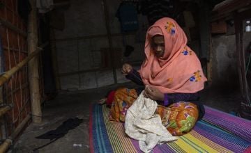 Rumaina is sewing clothes in her home at the Rohingya refugee camp, Cox’s Bazar. Photo: Saikat Mojumde