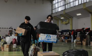 People loading trucks with supplies from the local sports hall in Sighetu Marmatiei, Romania. Supplies are bound for Ukraine.