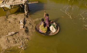 Local boy, Aqib Aliin, 14. transports people on his curry frying pan across the flooded waters in Jhuddo town of District Mirpurkhas of Sindh 