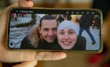 Sofia looking at pictures of her life in Ukraine. She has had to leave her job as a nurse, her husband and extended family behind. Sofia and her son fled from Ukraine to Romania. With no money or anywhere to go, they have been living of the kindness of strangers to get by.