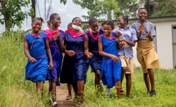 Aminata (15) and her fellow pupils beside the Girls toilets of Benevolent Islamic PRI School in Yele town