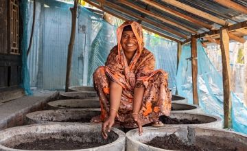 Asma Begum pictured with the compost she has made thanks to training in climate smart agricultural techniques