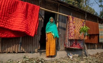 Malika Begum stands outside her house. She is part of the Zurich programme which helps tackle the annual problem of flooding in communities. Photo: Gavin Douglas