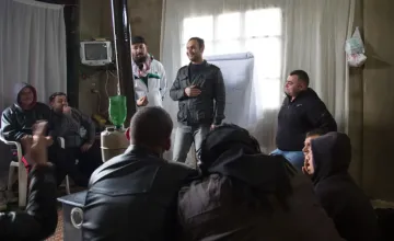 A view inside a Men’s Protection Group meeting of Syrian refugees in Lebanon. These men have gathered to talk through their experiences and collectively work on building a community, which has proven to assist mental wellness and decrease negative coping mechanisms like gender-based violence.