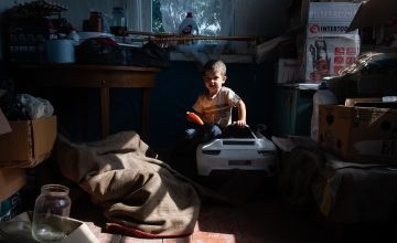 Lesya's three-year-old son inside the relative's house they have moved to after fleeing their home close to the Russian border