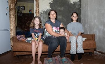 Lesya* (33) with her three children in a relative's house in the Sumy region after they fled their home village, located just a kilometre from the border with Russia