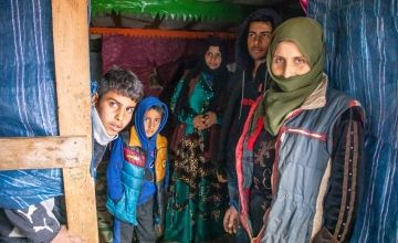 Fatima and her family pictured in their makeshift tent.
