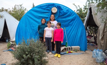 Erva* and her daughters outside of their tent