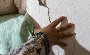 Razia* shows us the huge cracks through the old house she used to live in