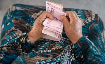 A detail shot shows Shahinaz* counting the money she has received from a cash support distribution centre at a camp in north-west Syria on 22 June 2023. As part of Concern Worldwide’s response to the Syria-Turkey earthquake, cash assistance is distributed to displaced families living in camps and temporary shelters to meet their immediate basic needs. After an informational session, each household receives a cash voucher at the distribution point.