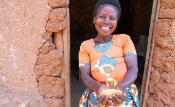 Mother-of-five Marie-Claire Ayinkamiye (45) lives alone with her five children. She has built a new house and owns a cow, goat and pig in Muganza, Gisagara. Marie-Claire runs a successful business selling grains and legumes. In her home, she stores two sacks of sorghum and one of soya beans that she has harvested from her two plots of land, and a sack of rice that she bought. Photo: Eugene Ikua/Concern Worldwide