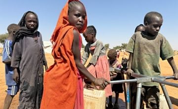 Children collect water at a borehole inside the Adré refugee settlement in Chad.