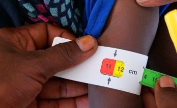 An example of a MUAC band being used. The band has stopped at red, indicating acute malnutrition. Photo: Eugene Ikua/Concern Worldwide