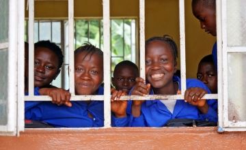 Mariama M Turay (left, 12) and Mary Sesay (12, right) following a class 6 lesson at the Muslim Brotherhood School in Masakong, Sierra Leone. The school participated in an integrated program led by Concern that included the Safe Learning Model to reduce and prevent SRGBV. (Photo: Conor O'Donovan/Concern Worldwide)