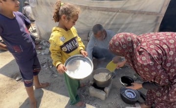 Hassan* (48) and Mariam* (34) prepare dinner for their family of seven in Rafah. They have been displaced more than five times and struggle with getting enough food via aid distributions. (Photo: Concern Worldwide)